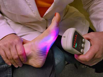 Dr. Markos using low level laser to treat Plantar Fasciitis